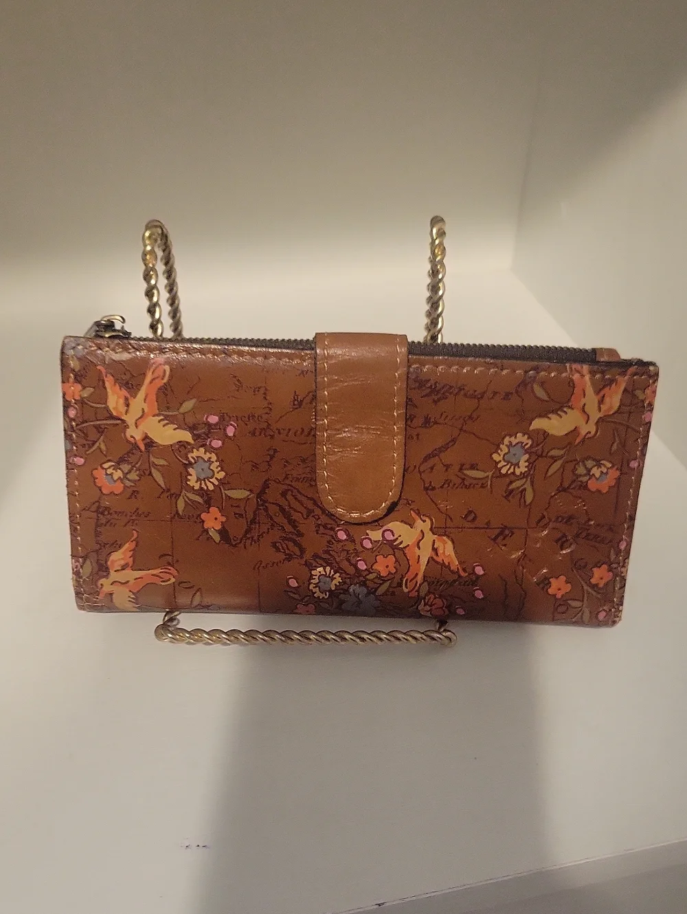 Brown leather Patricia Nash bifold wallet featuring an artistic vintage map back